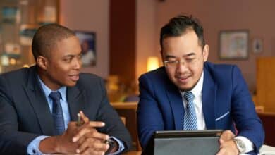 Diverse legal professionals collaborating on a tablet for the Weil Legal Innovators Program 2026.