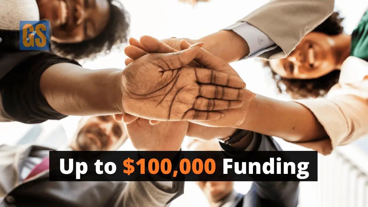 A collaborative community team joining hands for the Aboriginal Community-Led Cancer Research Grant 2026 project in Australia.