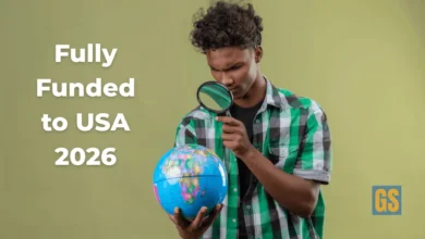 A young researcher examining a globe with a magnifying glass for the Tufts One Health Fellowship 2026 program.