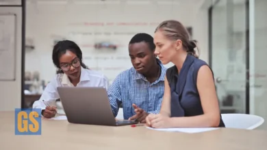 Group of diverse young professionals collaborating on a laptop in a modern office for Virginia Governor’s Fellows Program 2026.