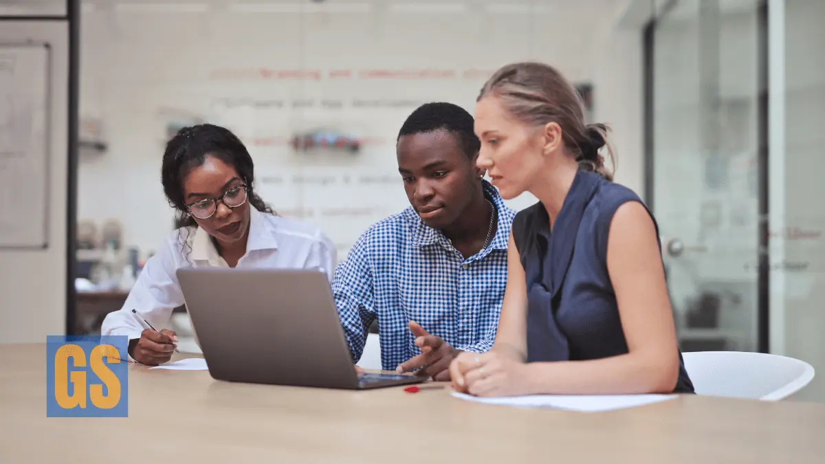 Group of diverse young professionals collaborating on a laptop in a modern office for Virginia Governor’s Fellows Program 2026.